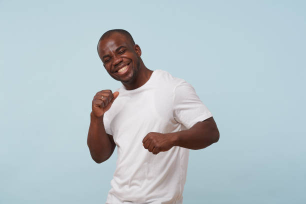 istock Handsome black man smiling, against pale blue background. 1097156152