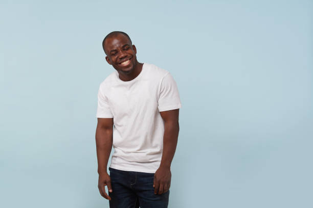 istock Handsome black man smiling, against pale blue background. 1097156162