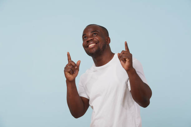 istock Handsome black man smiling, against pale blue background. 1097156164