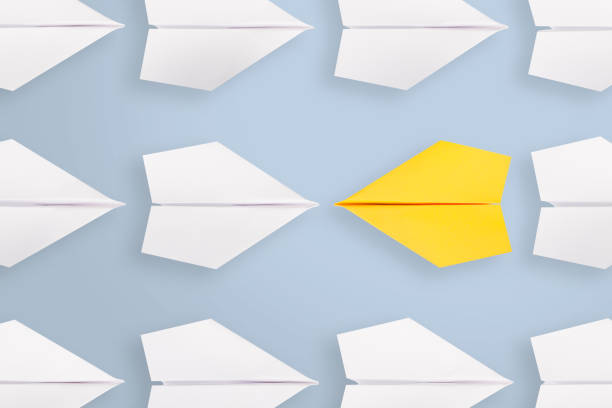 istock Change concepts with yellow paper airplane leading among white 1097156982