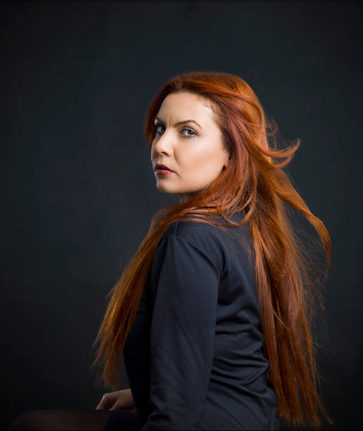 istock Seductive woman posing over black background 1097157060