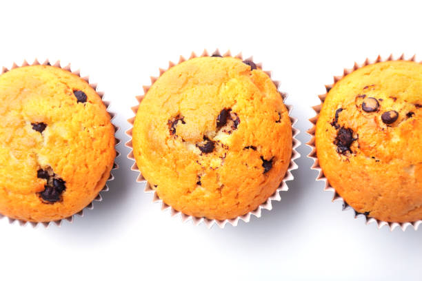 istock Assorted with Delicious homemade cupcakes with raisins and chocolate isolated on white background. Muffins. Top view. Copy space. 1097158556