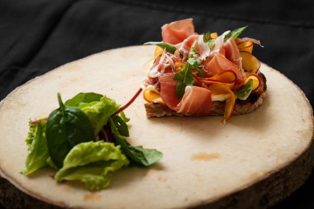istock Close up sandwich with jamon and salad on board 1097160060