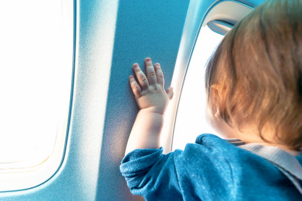 istock Toddler boy looking out a plane window 1097162196