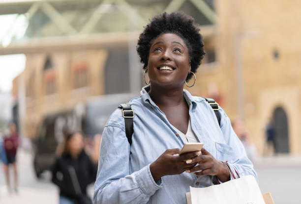 istock Shopping woman texting on her phone 1097162434