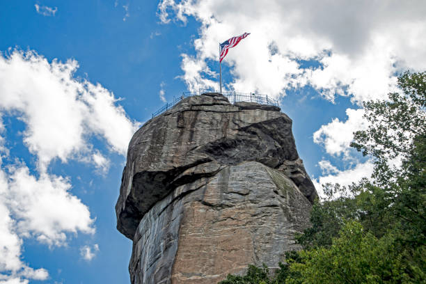istock Chimney Rock State Park flag flying against a clear blue sky. 1097162842