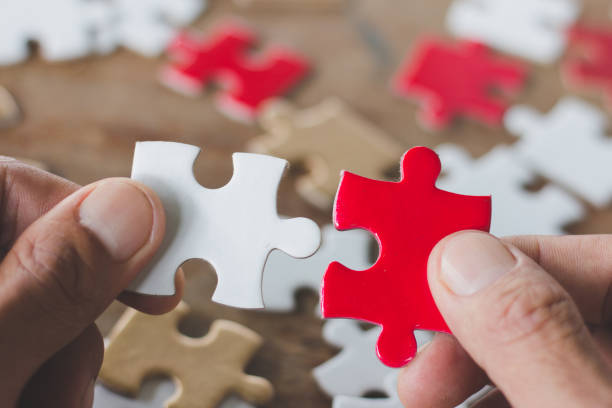 istock Business solutions, success and strategy concept. Businessman hand connecting jigsaw puzzle 1097166328