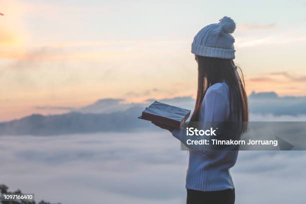 Woman Holding Reading Bible On Mountain In The Morning Image Stock Photo - Download Image Now