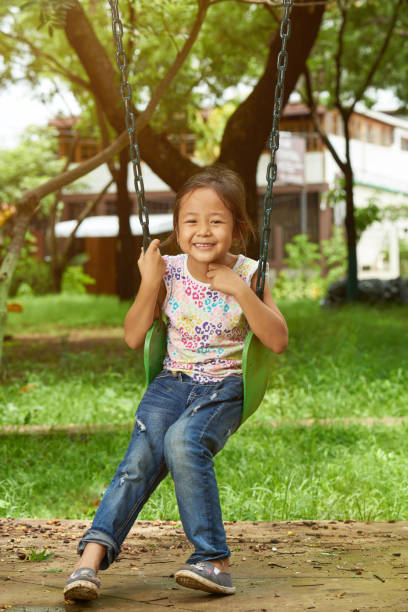istock Smiling asian girl on swings 1097167106