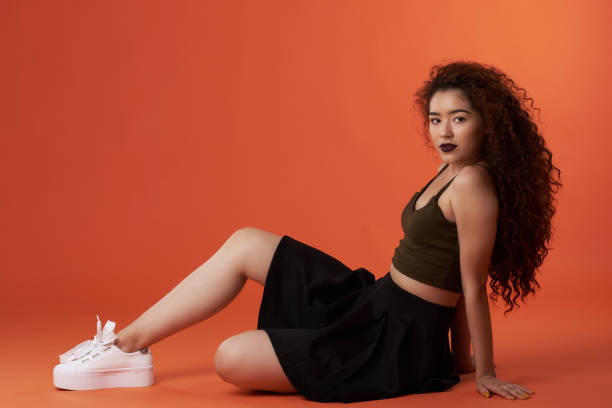 istock Young hispanic woman in sitting pose 1097170806