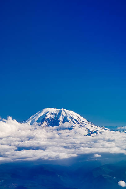Mountain Top Above Clouds with Blue Sky stock photo