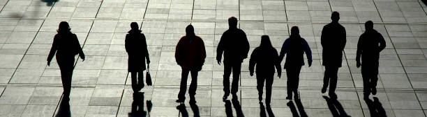 istock Silhouettes of People Walking Through Plaza 109718320