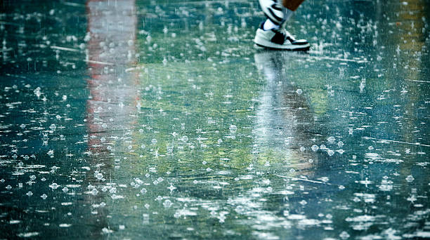 Man's Feet in the Rain stock photo