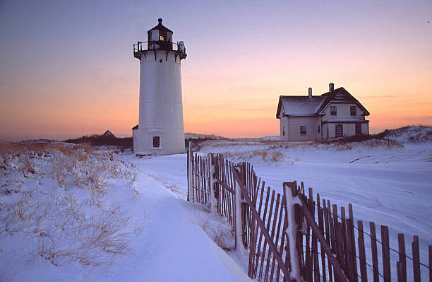istock Race Point Lighthouse and House with Snowy Landscape at Sunset 109718504