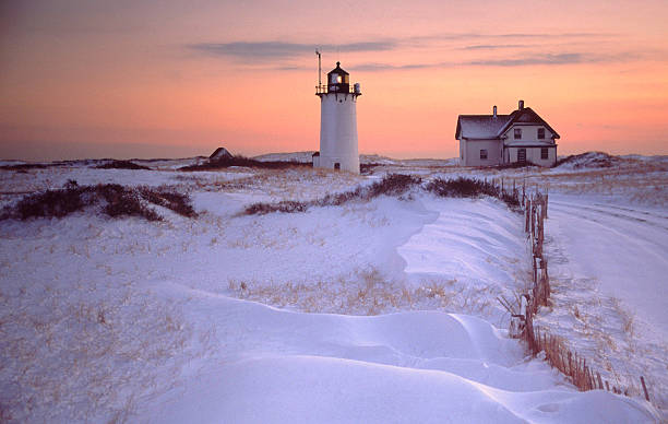 istock Race Point Lighthouse and House with Snowy Landscape at Sunset 109718561