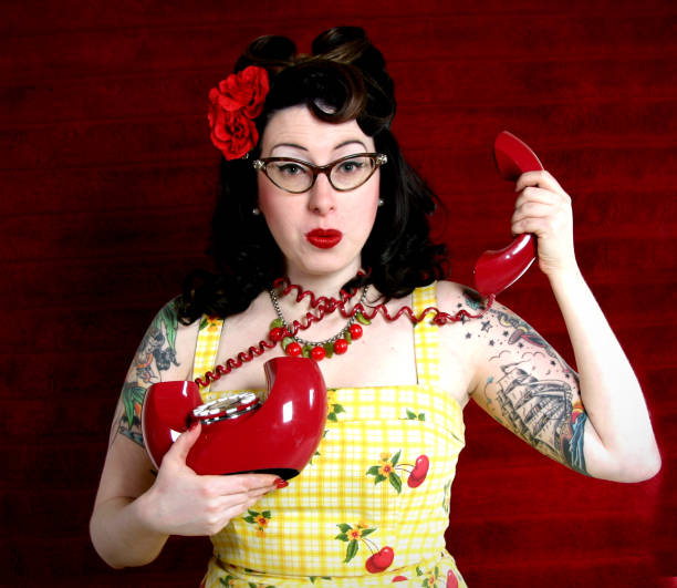 Attractive young woman tangled by telephone cord.