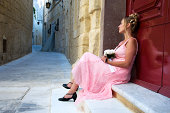 Young Woman Wearing Dress and Waiting Outside