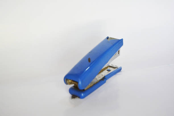 Blue stapler and staples on a white background for business