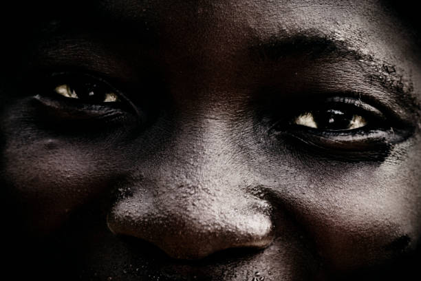 Young playful couple in African masks