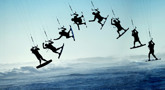 Silhouette Sequence of Surfing Kite Boarder Jumping