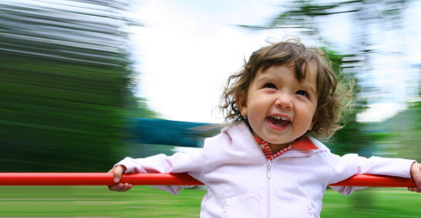Toddler playing in public park, blurred motion