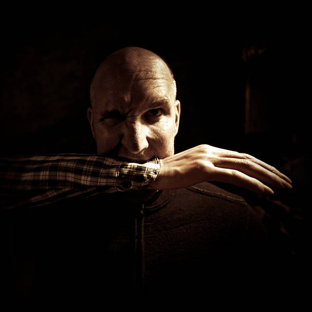 istock man with a severed arm in his mouth 109719171