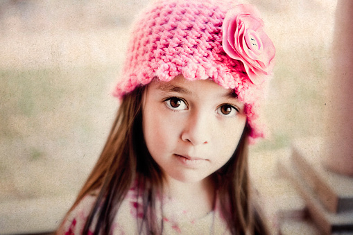 Portrait of pretty little girl in a dress, outdoors