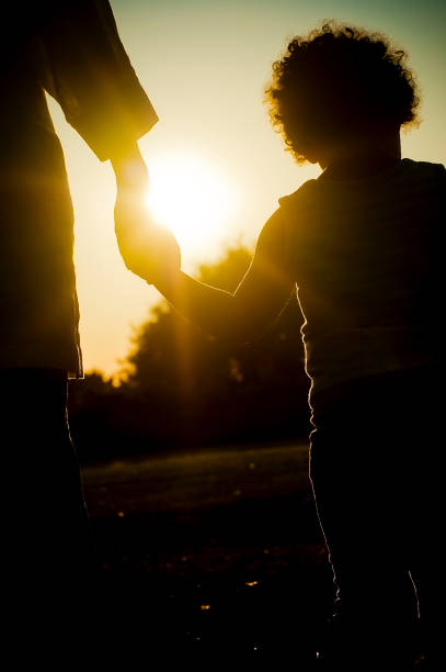 istock Silhouette of Child holding her mum's hand 109719251
