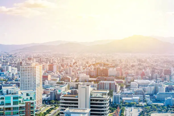 Asia Business concept for real estate and corporate construction - panoramic urban townscape aerial view under bright blue sky and sun in Fukuoka Japan