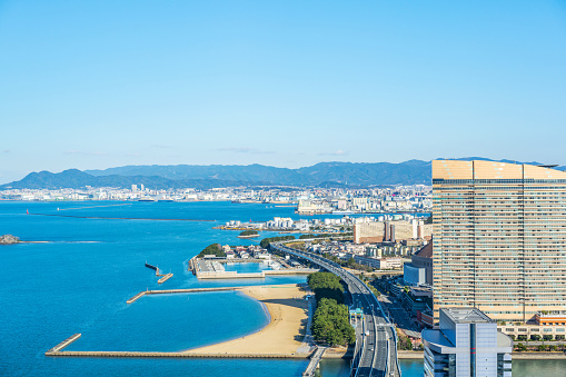 Asia Business concept for real estate and corporate construction - panoramic urban townscape aerial view of beach park under bright blue sky and sun in Fukuoka Japan