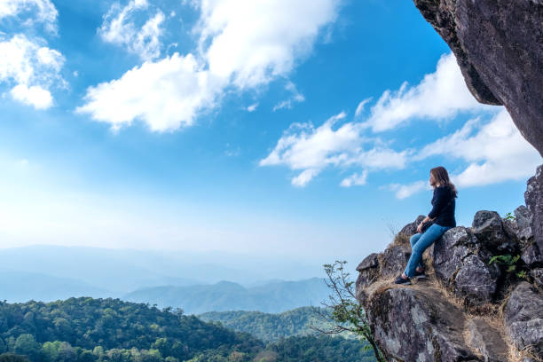 istock A beautiful asian woman sitting on a cliff 1097197798