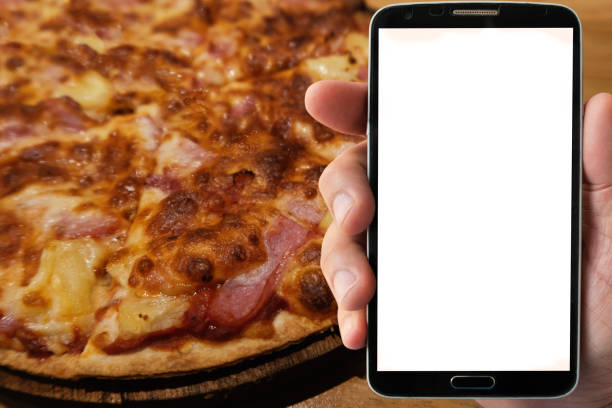 istock blank screen mobile in hand with blurred pizza background for advertise concept 1097199668