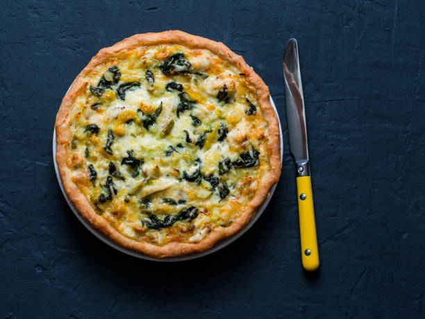 istock Chicken, leek, cheese, spinach quiche on dark background, top view 1097200438
