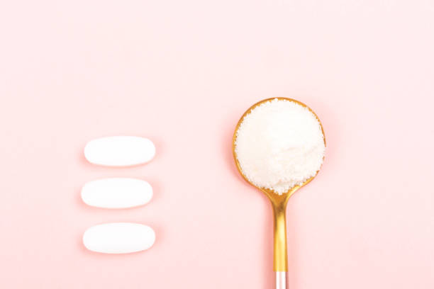 istock Collagen powder on pink background 1097201762