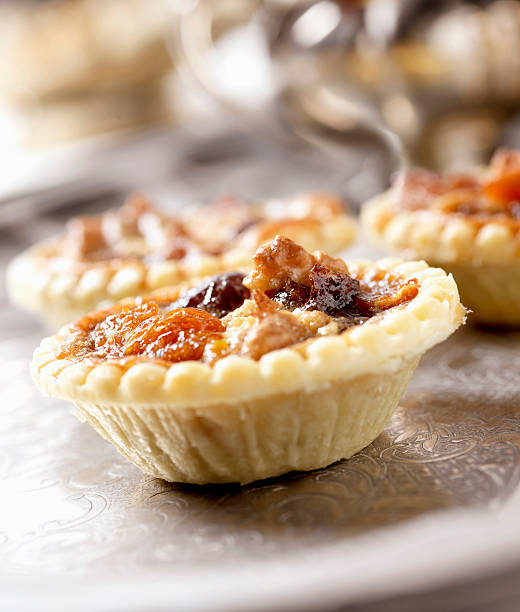 Tray of pastries with nuts and berries. There are many of them. They are all different sizes