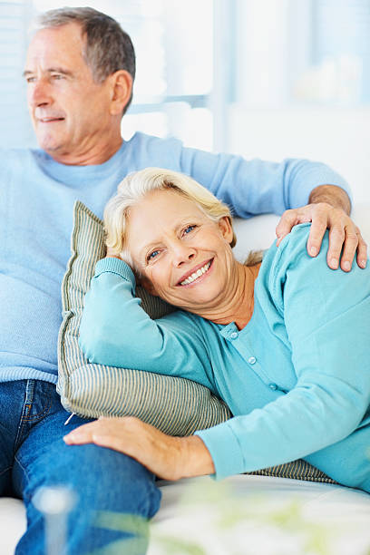 istock Smiling relaxed couple on a couch at home 109720352