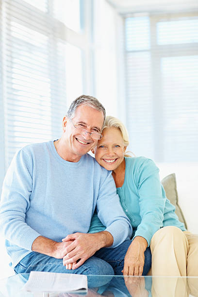 istock Smiling retired couple sitting together at home 109720378