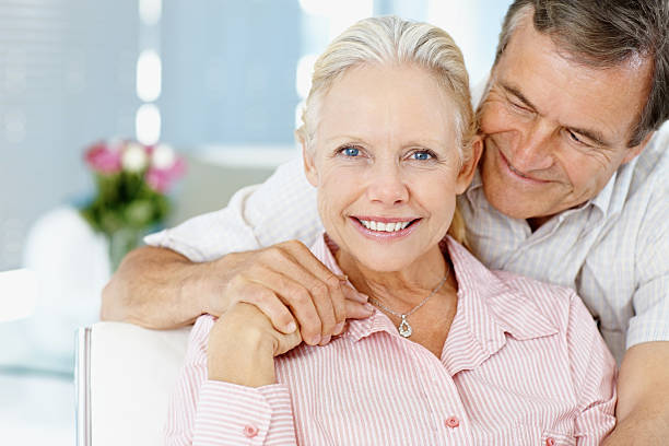 istock Old man hugging a cute mature woman from behind 109720380