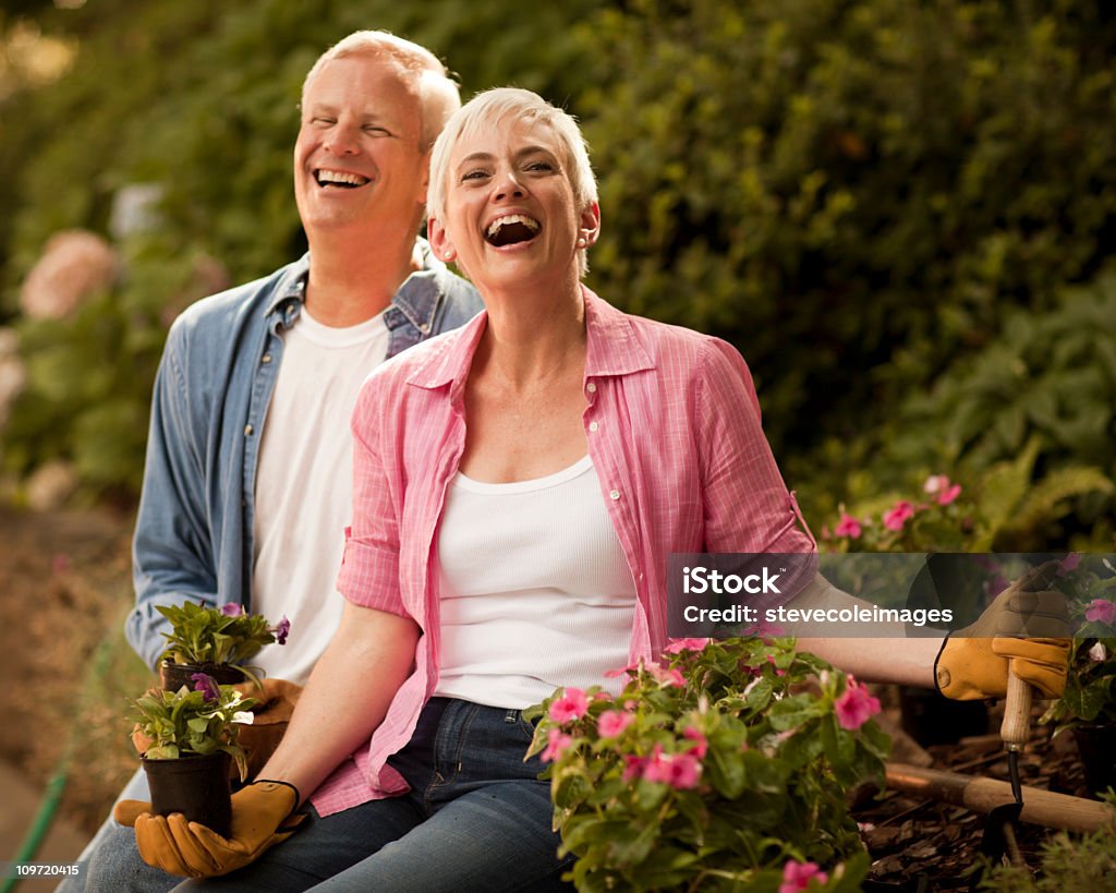 Senior Couple Laughing in Flower Garden  Flower Stock Photo