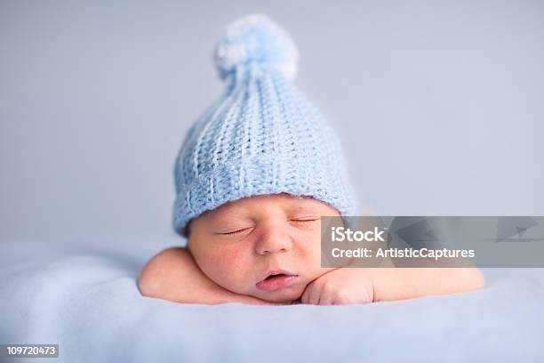 Newborn Baby Boy Sleeping Peacefully Wearing Knit Hat Stock Photo - Download Image Now