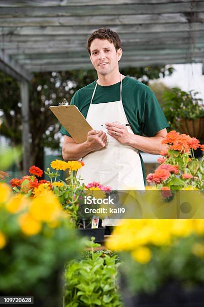 Worker Taking Inventory In Retail Garden Center Stock Photo - Download Image Now - 30-34 Years, 30-39 Years, Adult