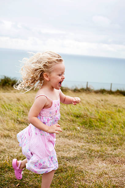 istock Little Girl Running in Field 109720723