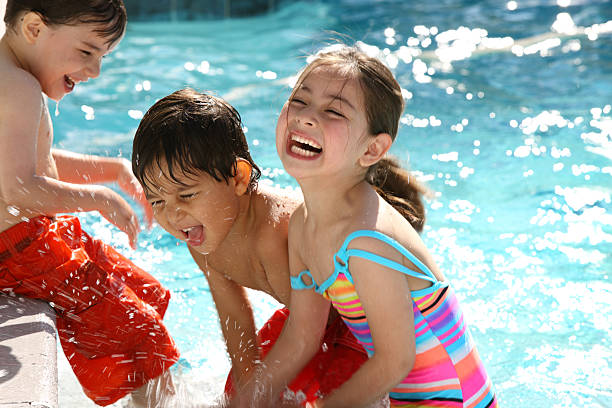 Laughing kids on swimming pool