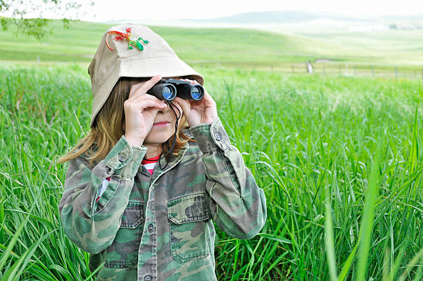 istock Young girl explores nature with binoculars 109720823