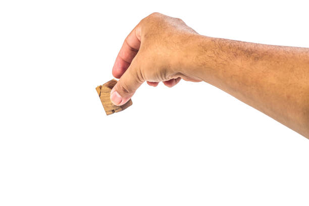 istock House wood miniature with hand on white background  . 1097208254