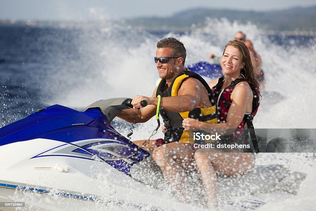 Szczęśliwy Dorosły para cieszy się jazdy na jetski - Zbiór zdjęć royalty-free (Jetboating)