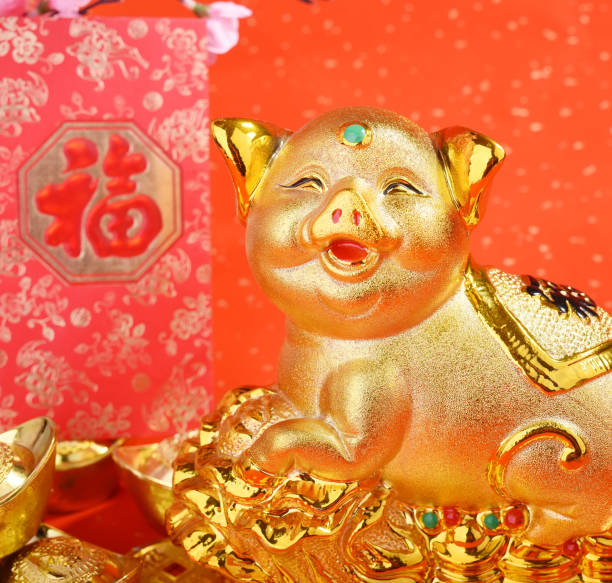 istock Golden pig statue on red background 1097209810
