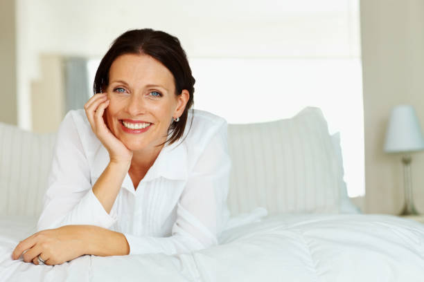 istock Smiling mature lady lying on bed 109720993