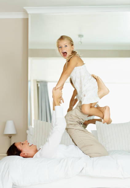 istock Mother playing with her excited daughter on bed 109721005