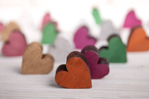 A colorful hearts on white wooden background stock photo
